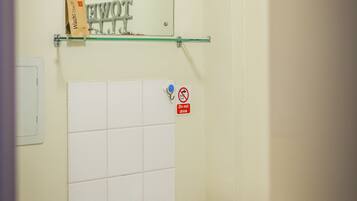 A bathroom with a white sink, a mirror, and a 'Do not drink' sign.