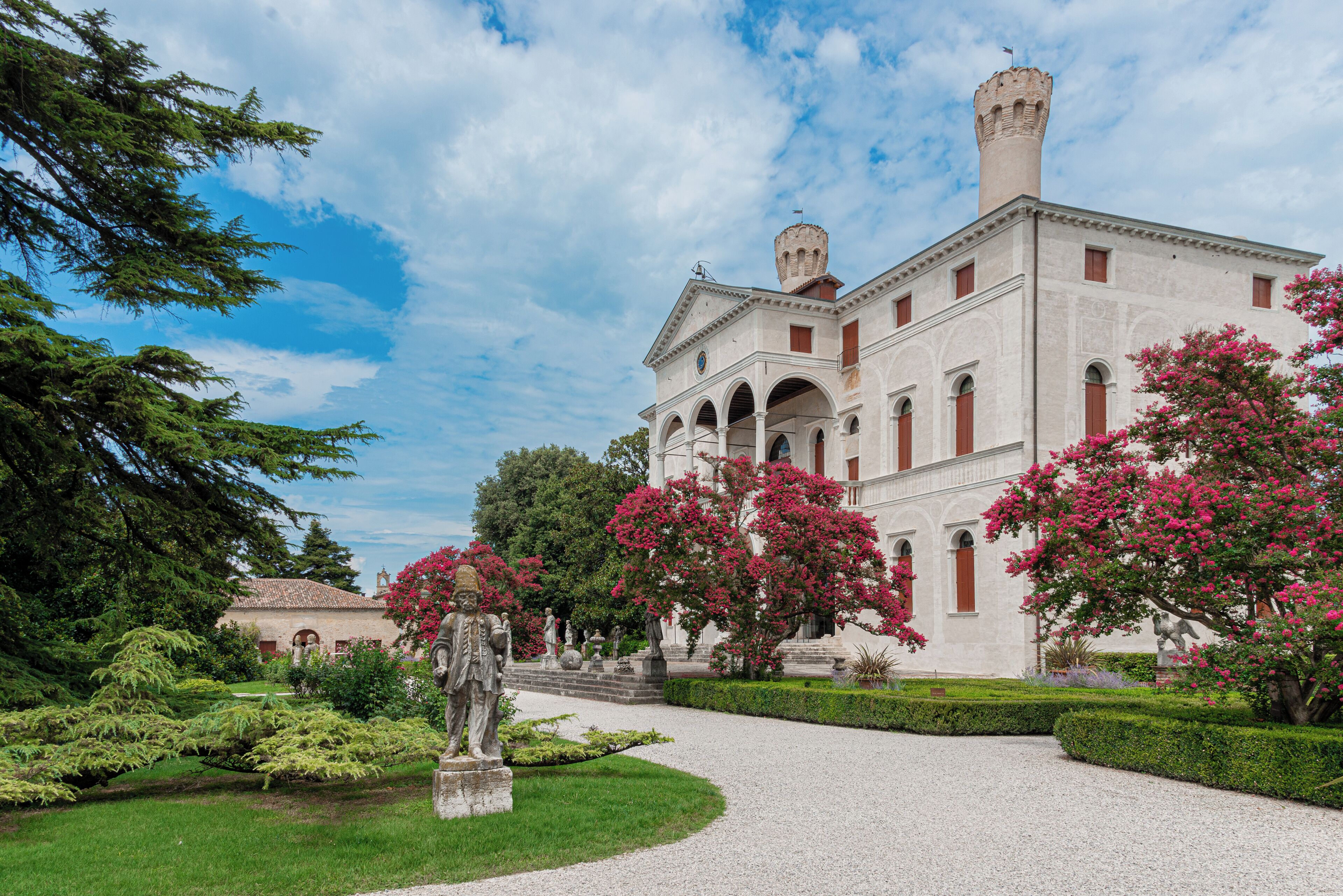 A historic building with a central courtyard, arched windows, and a tower.