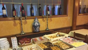 A buffet table with various food items and a selection of wine bottles. - Hotel Mondial (Rapallo)