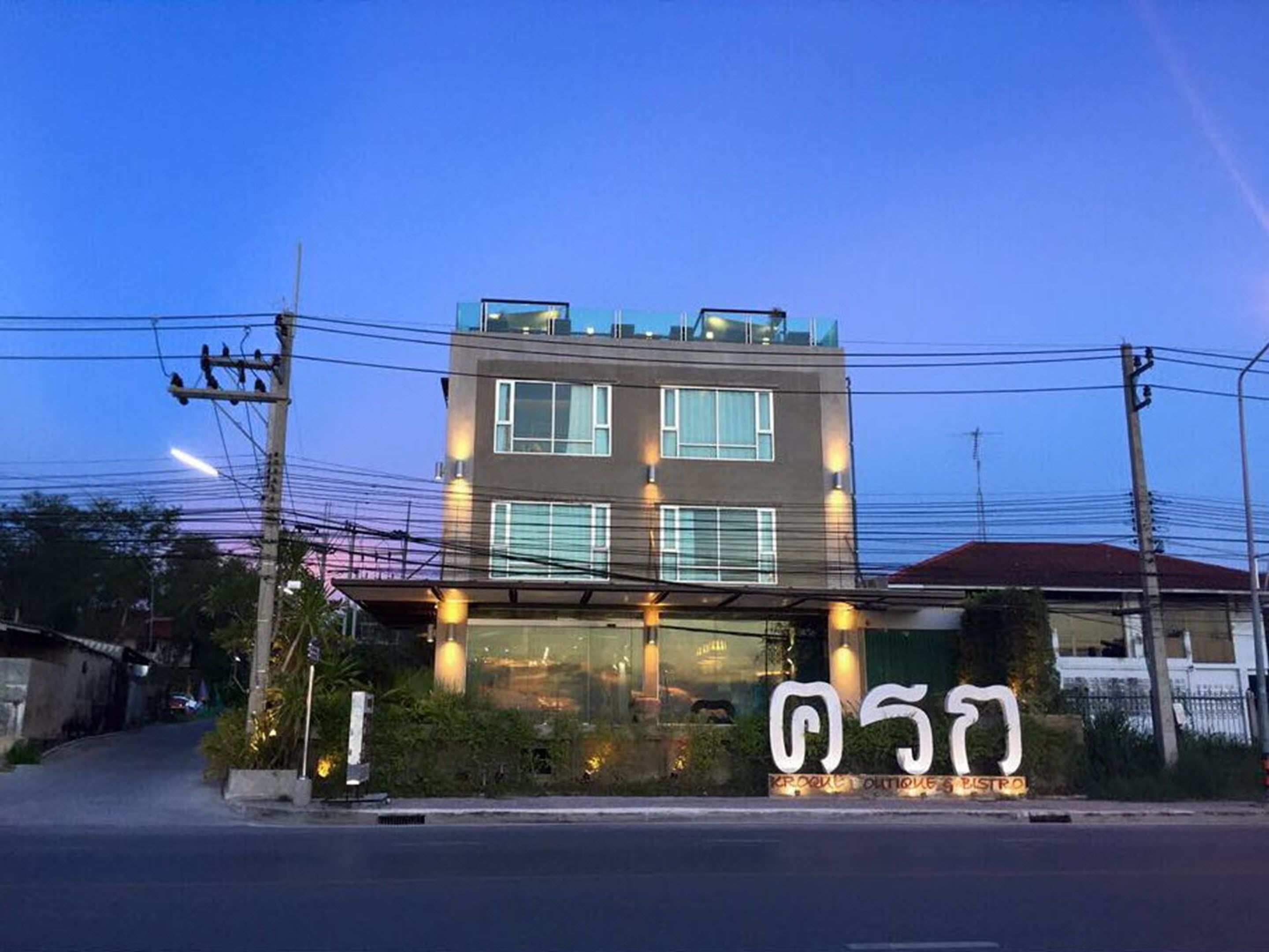 Edifici modern amb façana de vidre i un rètol que indica un restaurant.