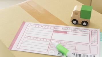 A package with a shipping label and a toy truck.