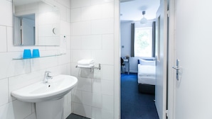 A modern bathroom with a white sink, mirror, and glass shelf. - Arcade Hotel Hamburg (Hamburg)