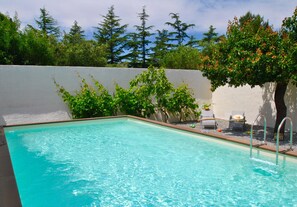 Outdoor pool, open 10:00 AM to 7:00 PM, pool loungers