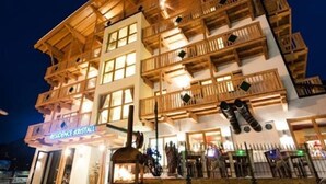 A multi-story building with a wooden facade, balconies, and a sign reading "RESIDENCE KRESTAL". - Appart Residence Kristall by Skinetworks (Saalbach-Hinterglemm)