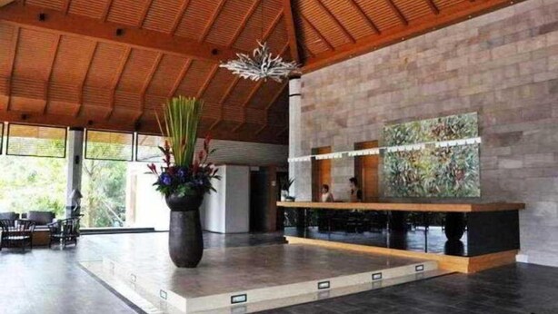 A spacious lobby with a high ceiling, a reception desk, and a large abstract painting on the wall. - The Greenery Resort Khao Yai (Pak Chong)