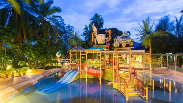 A water park with a central water slide, a play structure, and surrounding palm trees. - The Greenery Resort Khao Yai (Pak Chong)