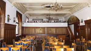 A grand hall with ornate ceiling and chandeliers, wooden tables and chairs arranged for dining or meetings. - Hotel Neustädter Hof (Titisee-Neustadt)