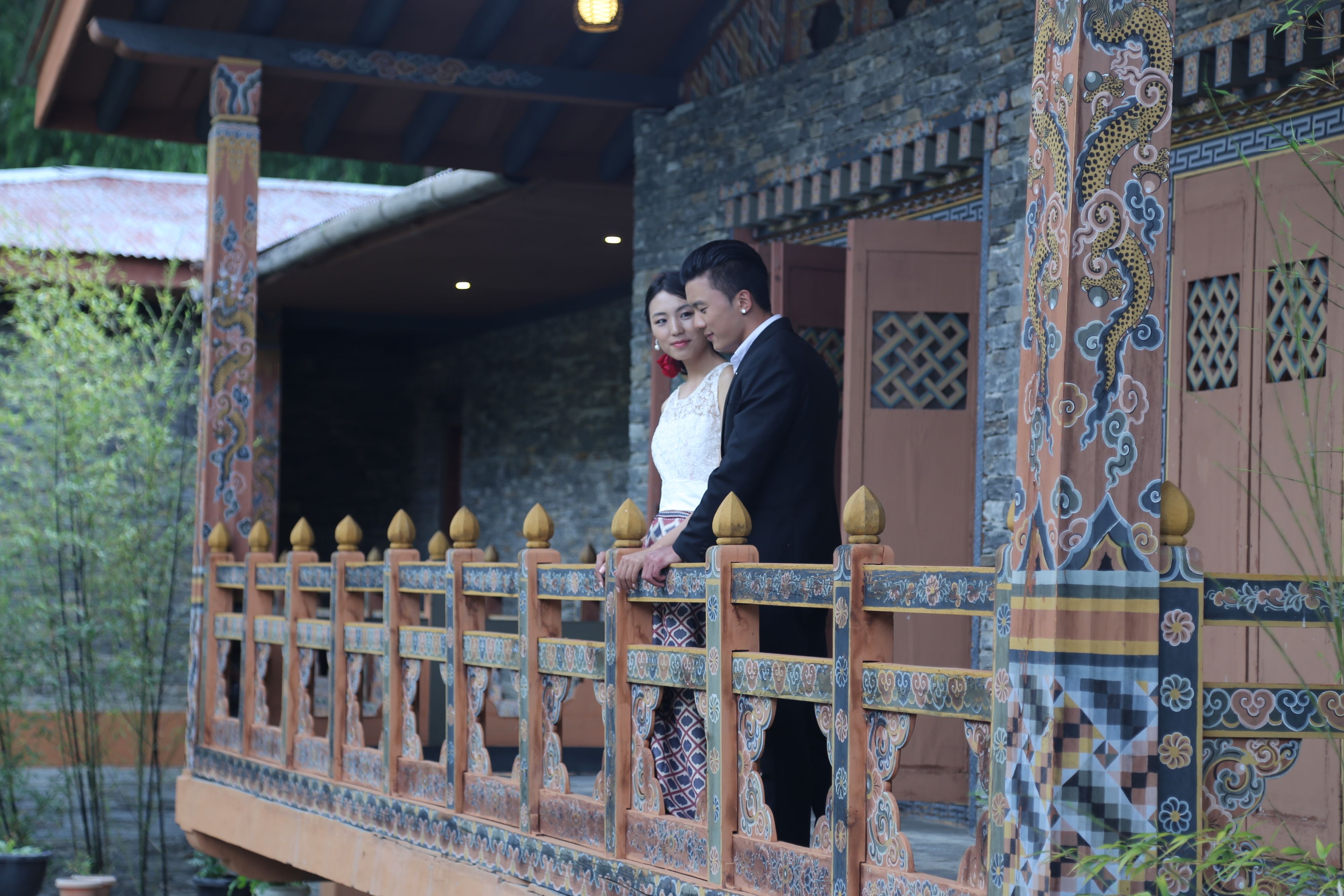 A traditional building with ornate wooden railings and a balcony.
