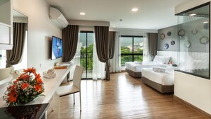 A modern hotel room with a large bed, a desk, and a dining area. - Cmor by Recall Hotels, Chiang Mai (Chiang Mai)
