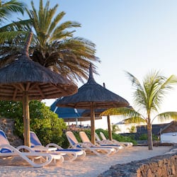 In Strandnähe, weißer Sandstrand, Liegestühle, Sonnenschirme