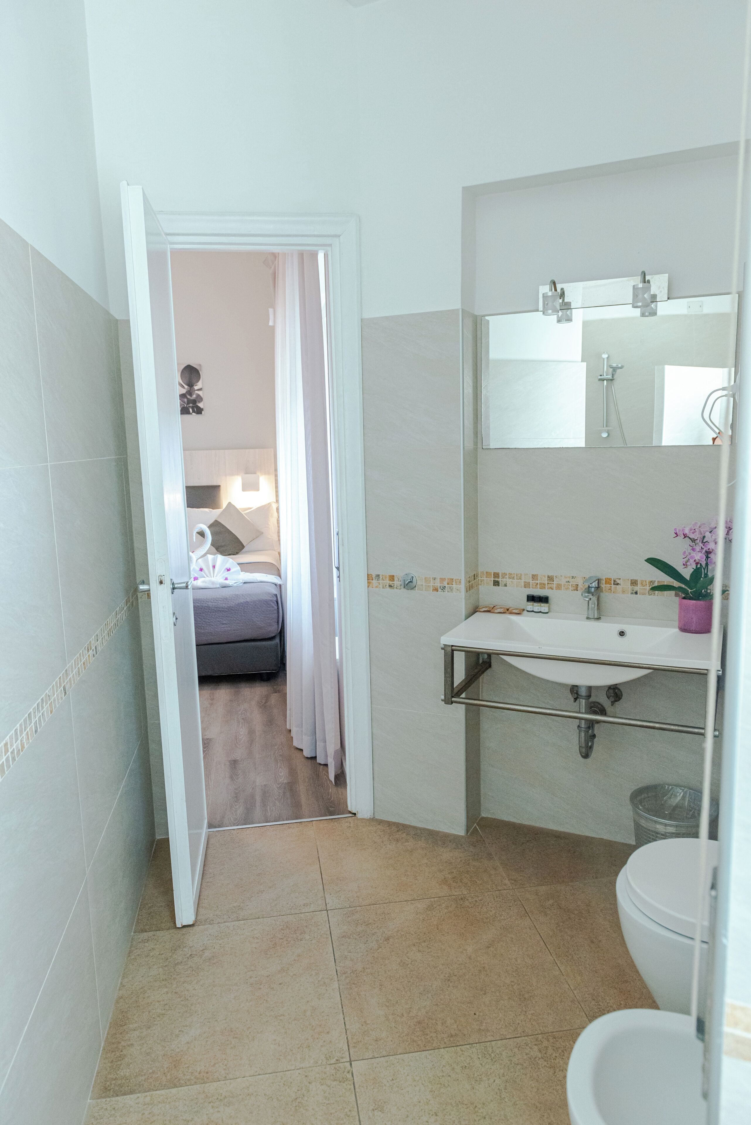 Een badkamer met een wastafel, spiegel en toilet.