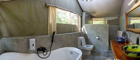 A bathroom with a bathtub, toilet, and sink.