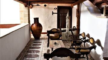 Experience a warm and inviting atmosphere in this traditional space, featuring a stone-tiled floor and ornate decor.