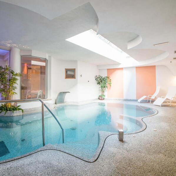 Indoor pool, a waterfall pool, pool loungers