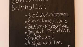 A blackboard with a list of breakfast items written in white chalk.