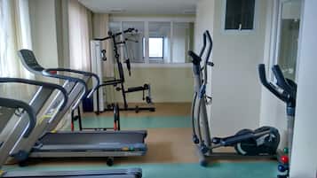 A fitness room with treadmills, elliptical machines, and a stationary bike.