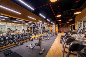 Stay fit on the go with our fully equipped gym featuring dumbbells, weight machines, and treadmills.