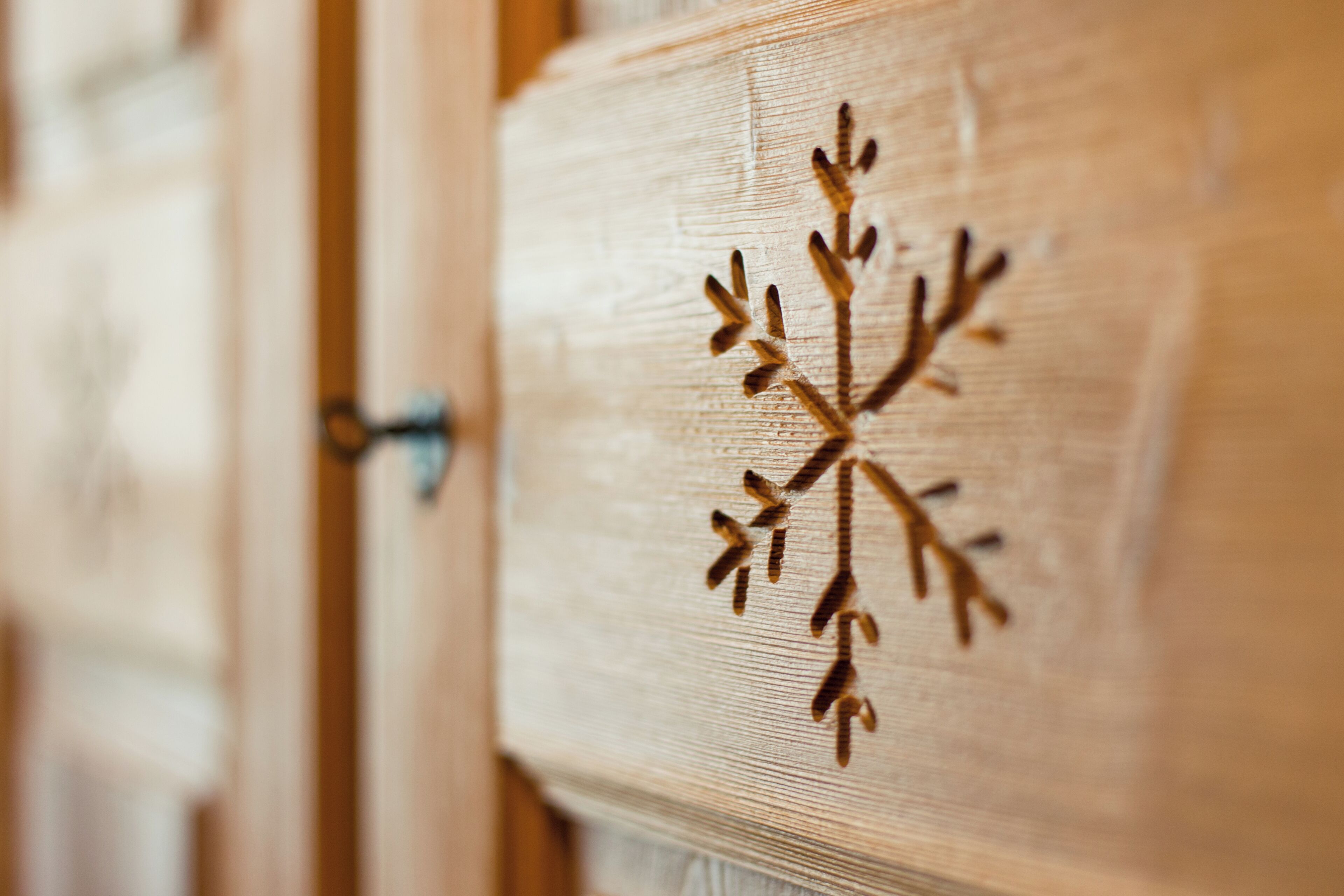 A wooden panel with a snowflake design.