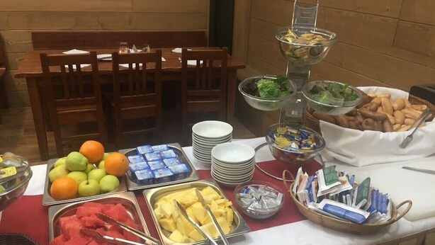 A buffet table with various food items including fruits, salads, and bread. - U Medvidku (Prague)