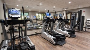 A gym with multiple treadmills and elliptical machines, equipped with digital displays. - Drury Inn & Suites Louisville North (Louisville)