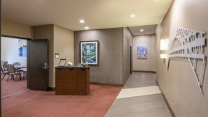 A hotel lobby with a reception desk, seating area, and artwork on the walls. - Hyatt Place Cleveland / Westlake / Crocker Park (Westlake)