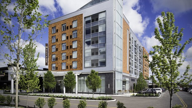 A modern multi-story hotel with a mix of brick and glass facades, large windows, and a landscaped entrance area. - Hyatt Place Cleveland / Westlake / Crocker Park (Westlake)