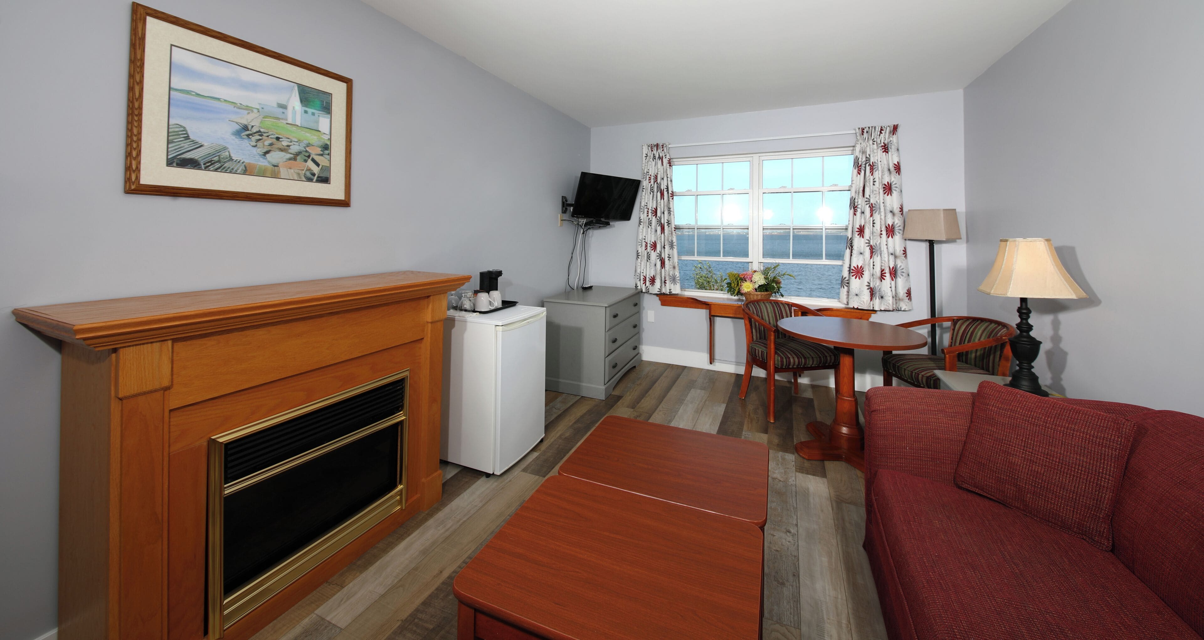 deluxe room, 1 king bed with sofa bed | living room | 32-inch flat-screen tv with satellite channels, tv, dvd player