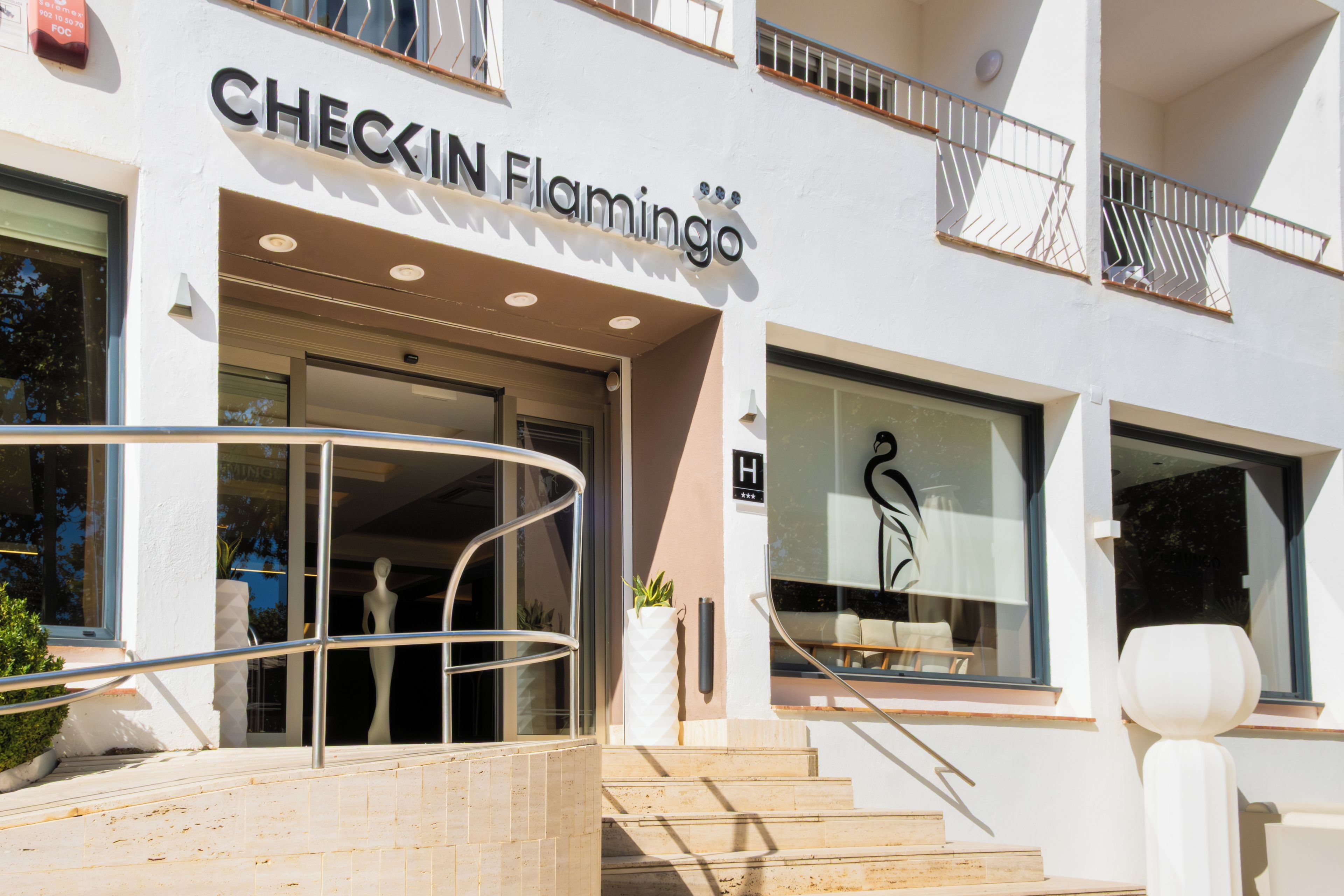 A hotel entrance with a sign reading "CHECKIN Flamingo".