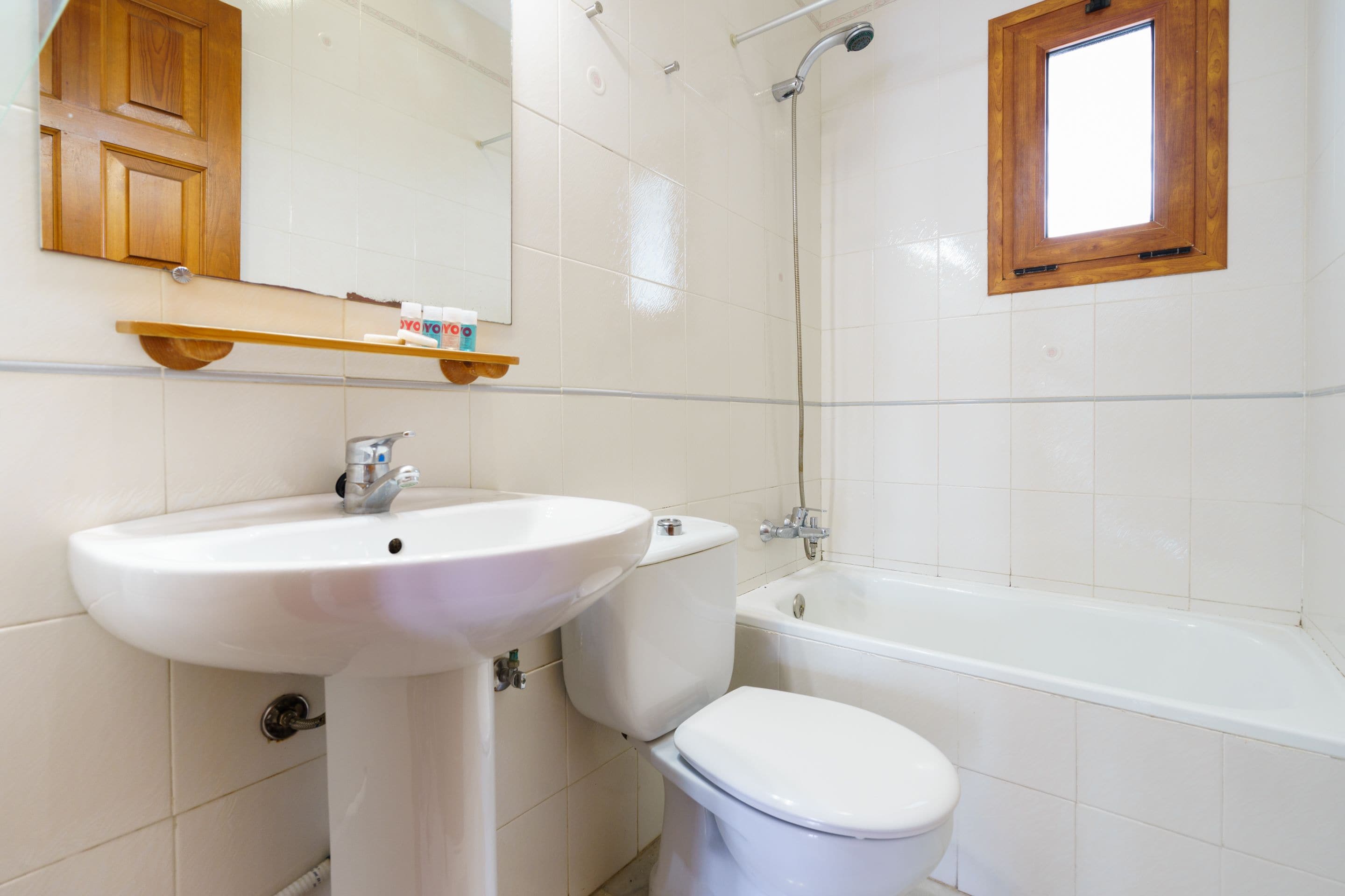 A bathroom with a white sink, toilet, and bathtub.