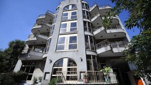 A multi-story building with balconies, large windows, and a staircase leading to the entrance. - Weygoss Guest House (Addis Ababa)