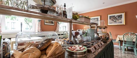 Una mesa de buffet con diversos alimentos y utensilios.