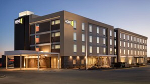 A modern hotel building with a flat facade, multiple windows, and a covered entrance area. - Home2 Suites by Hilton Gillette (Gillette)
