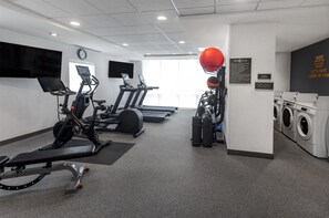 A gym with treadmills, stationary bikes, a rowing machine, a red exercise ball, and a laundry area. - Home2 Suites by Hilton Gillette (Gillette)