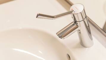 A modern bathroom sink with a chrome faucet and a single-handle design.
