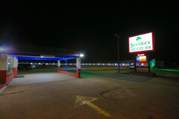 A well-lit parking area with a sign for Shamrock Country Inn.