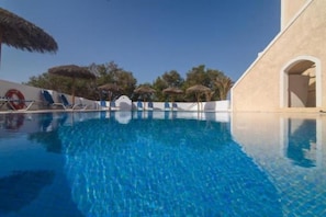 Outdoor pool, open 10:00 AM to 8:00 PM, pool umbrellas, pool loungers