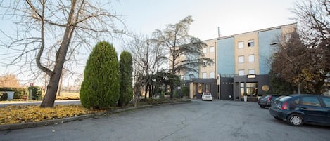 A parking lot with a building in the background.