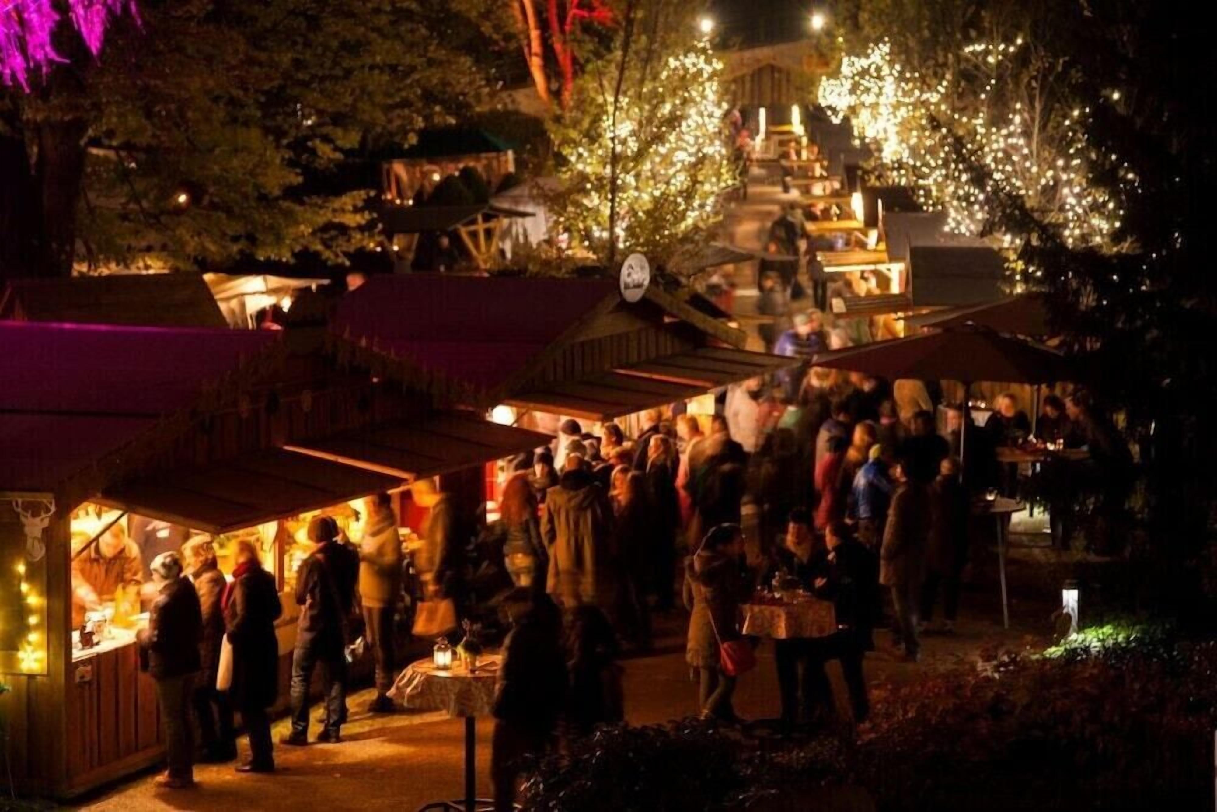 A crowded outdoor market with various stalls and people.