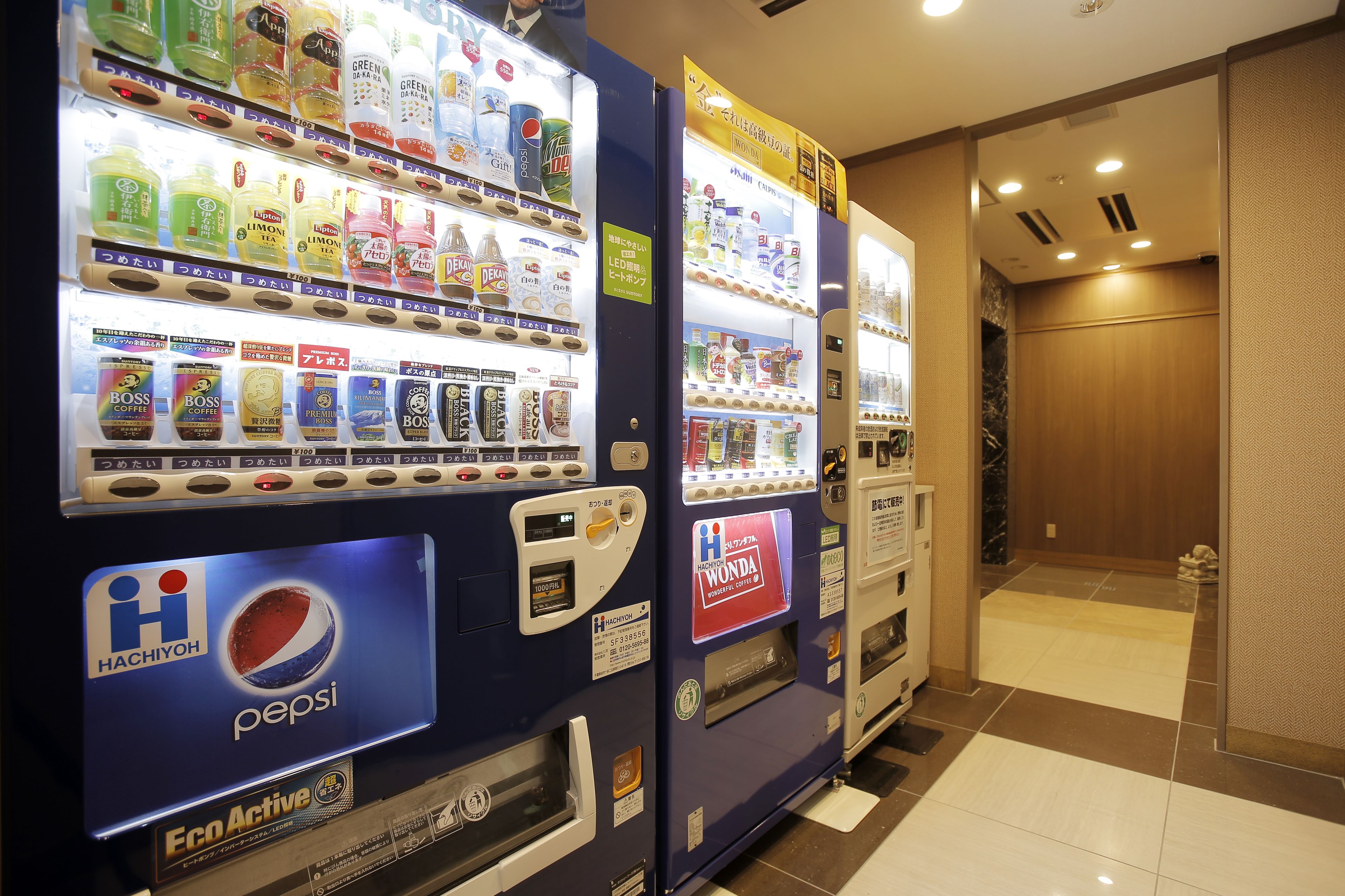 Vending machines with various beverages and snacks, including a Pepsi machine.