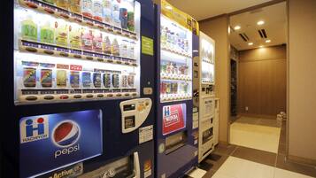 Vending machines with various beverages and snacks, including a Pepsi machine.