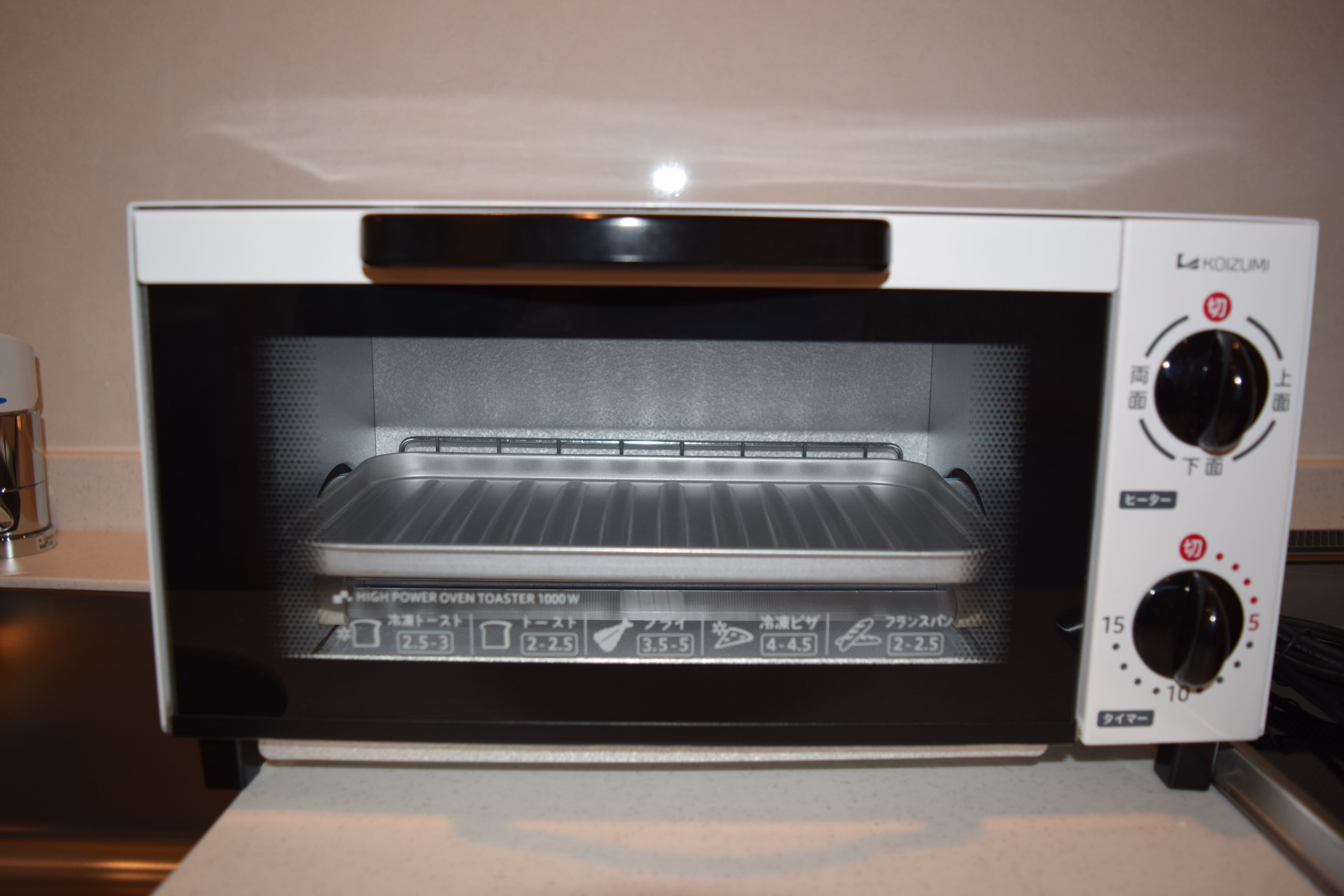 A high power oven toaster oven with a digital display and control knobs.