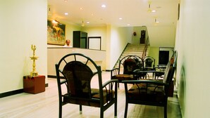 A spacious dining area with a high ceiling and recessed lighting. - Hotel Srinivas (Kanayannur)
