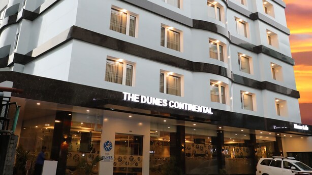 A multi-story hotel with a modern design, featuring a prominent sign for "The Dunes Continental." - The Dunes Continental (Kanayannur)