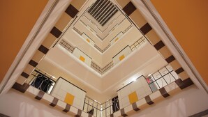 A multi-level atrium with a central open space and balconies. - The Dunes Continental (Kanayannur)