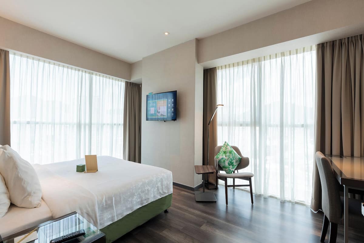 olive deluxe room | premium bedding, in-room safe, desk, laptop workspace