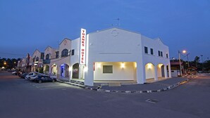 A hotel with a prominent 'Thanks Hotel' sign, a parking lot, and a street with other buildings. - Thanks Hotel (Nibong Tebal)