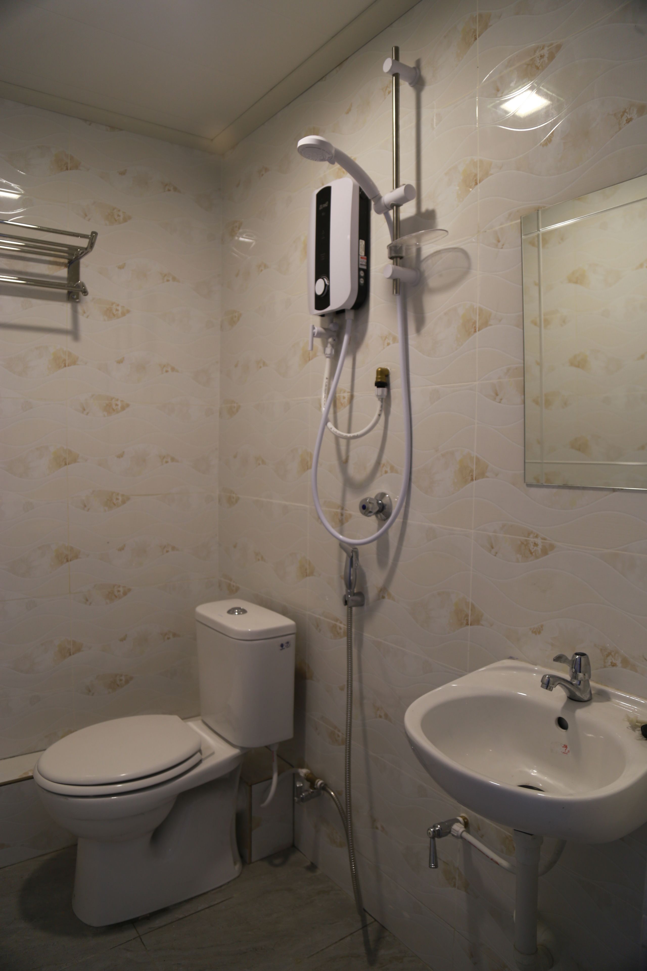 A bathroom with a toilet, a sink, and a shower.