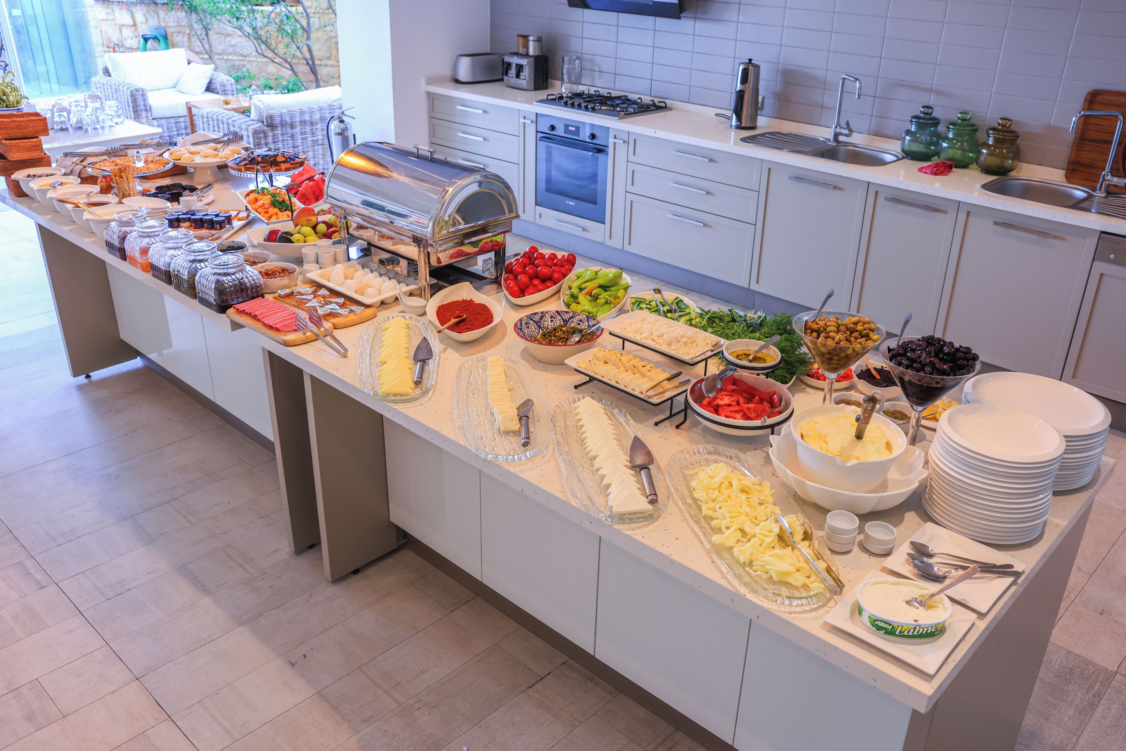 A buffet with a variety of food items and utensils.