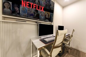 Work and unwind in style with a dedicated workspace and comfortable seating area.