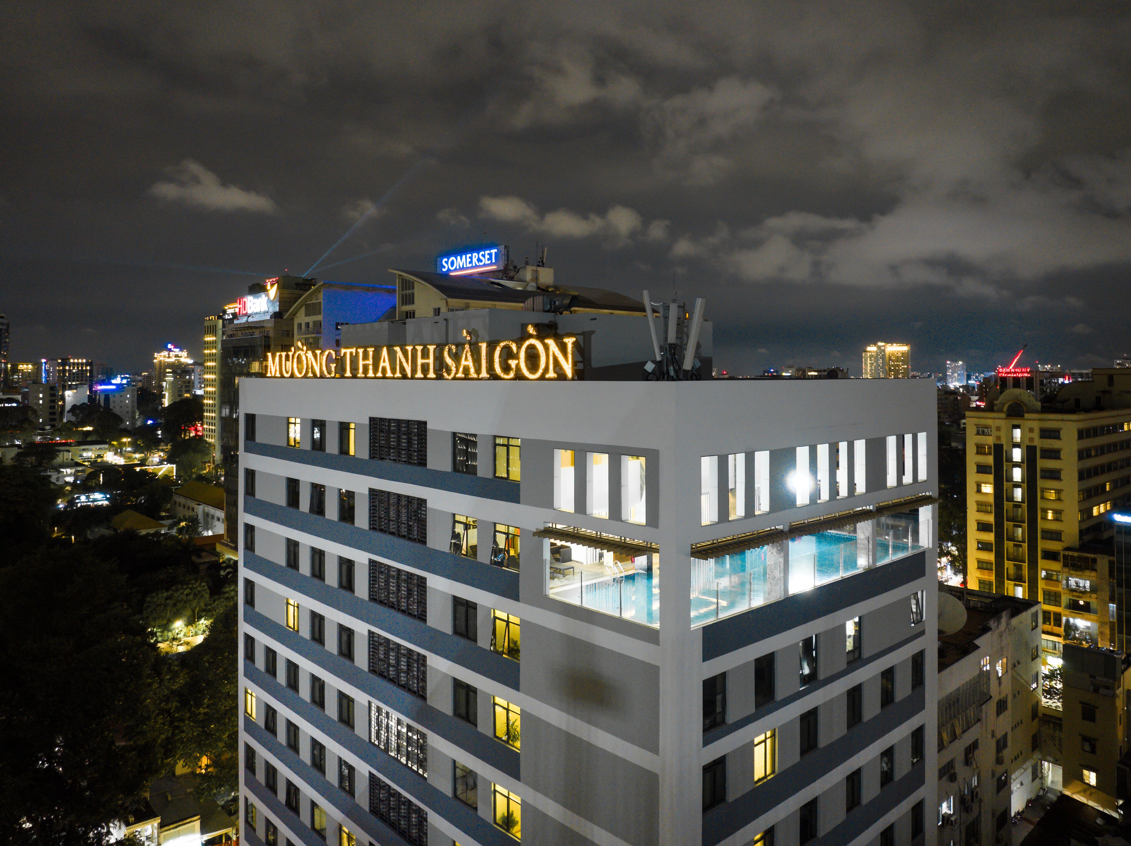 A hotel with a rooftop pool and multiple floors.